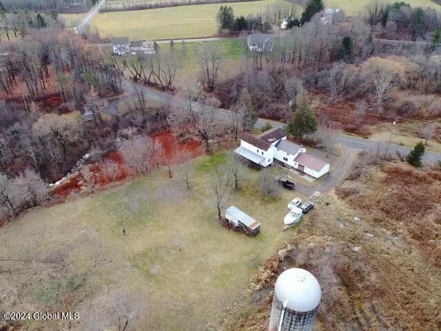 birds eye view of property with a rural view