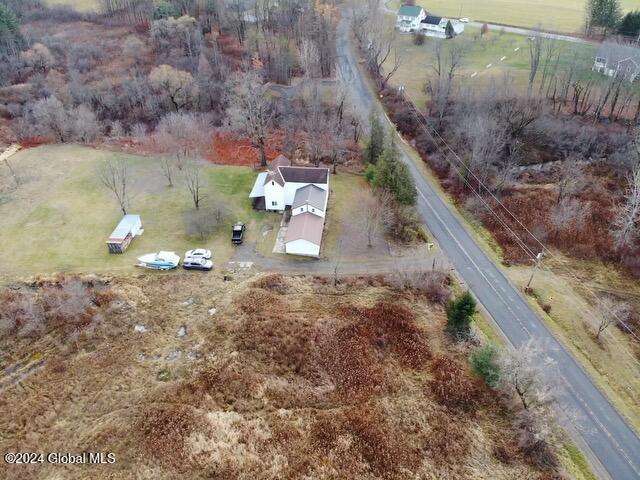 birds eye view of property with a rural view