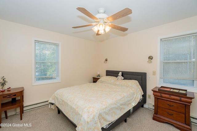 bedroom featuring a baseboard radiator, light colored carpet, and ceiling fan