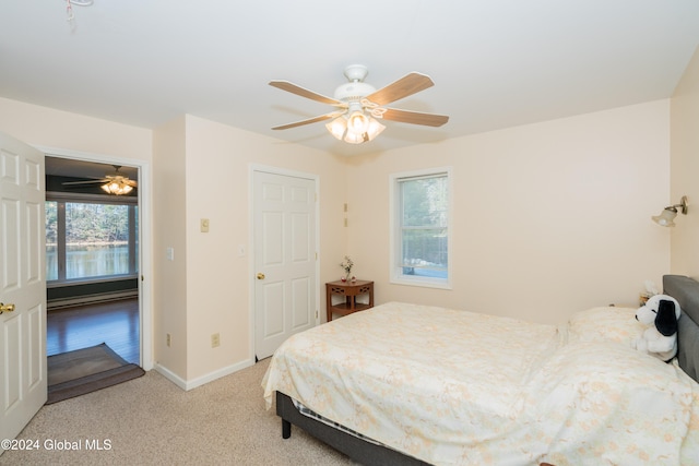 carpeted bedroom with multiple windows and ceiling fan