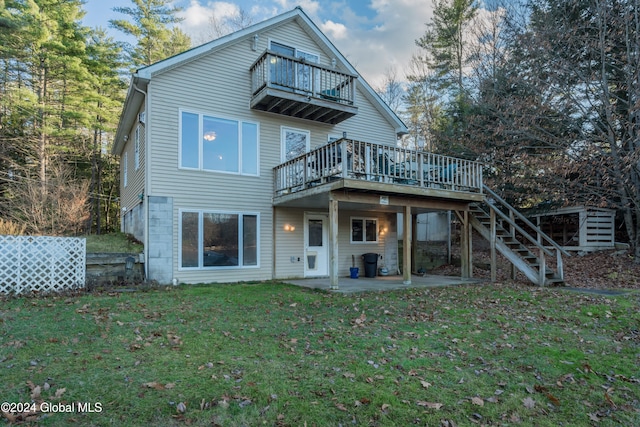 back of property with a lawn, a patio, and a deck