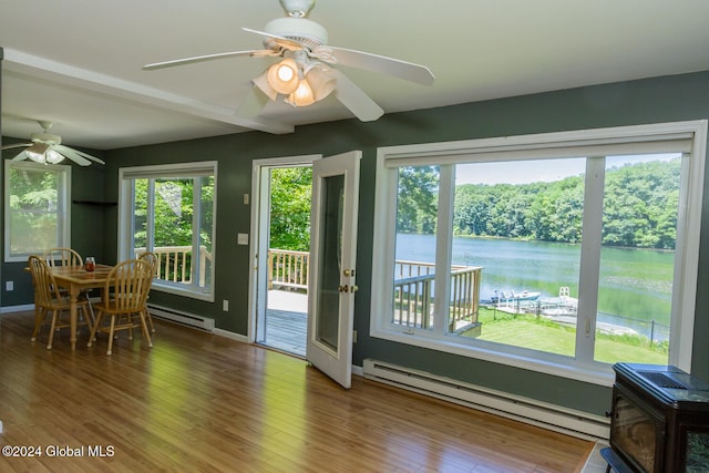 doorway featuring a water view, a baseboard radiator, wood-type flooring, and plenty of natural light