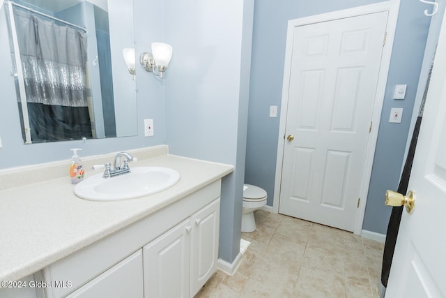 bathroom with vanity, tile patterned floors, and toilet