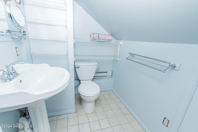 bathroom featuring tile patterned flooring, vaulted ceiling, toilet, and baseboard heating