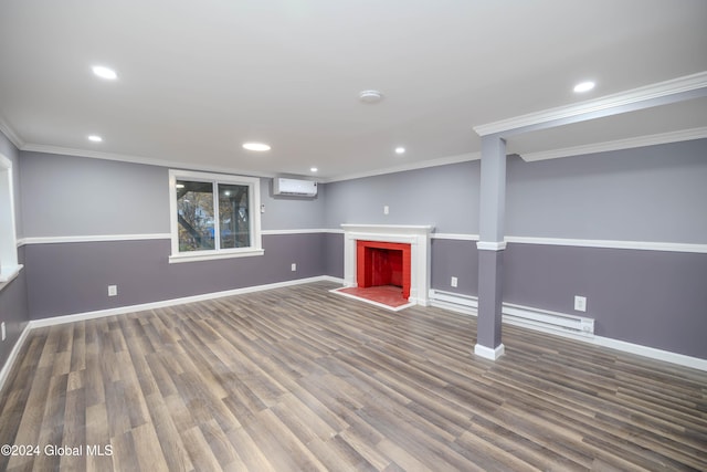 basement featuring crown molding, baseboard heating, dark wood-type flooring, and an AC wall unit