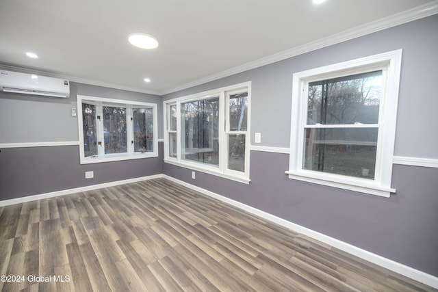 empty room featuring a wall mounted AC, dark hardwood / wood-style floors, and ornamental molding