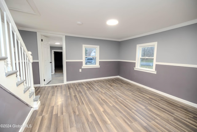 unfurnished room featuring hardwood / wood-style flooring and crown molding