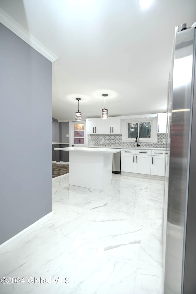 kitchen with white cabinets, pendant lighting, backsplash, and appliances with stainless steel finishes