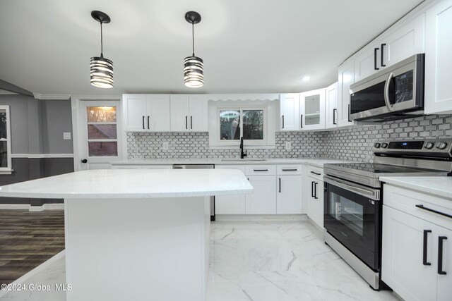 kitchen featuring white cabinets, appliances with stainless steel finishes, tasteful backsplash, and sink