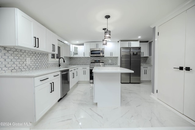 kitchen with decorative backsplash, white cabinetry, a center island, and stainless steel appliances