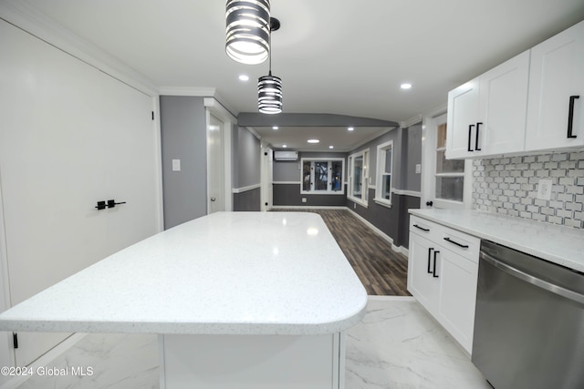 kitchen featuring dishwasher, a center island, and white cabinetry