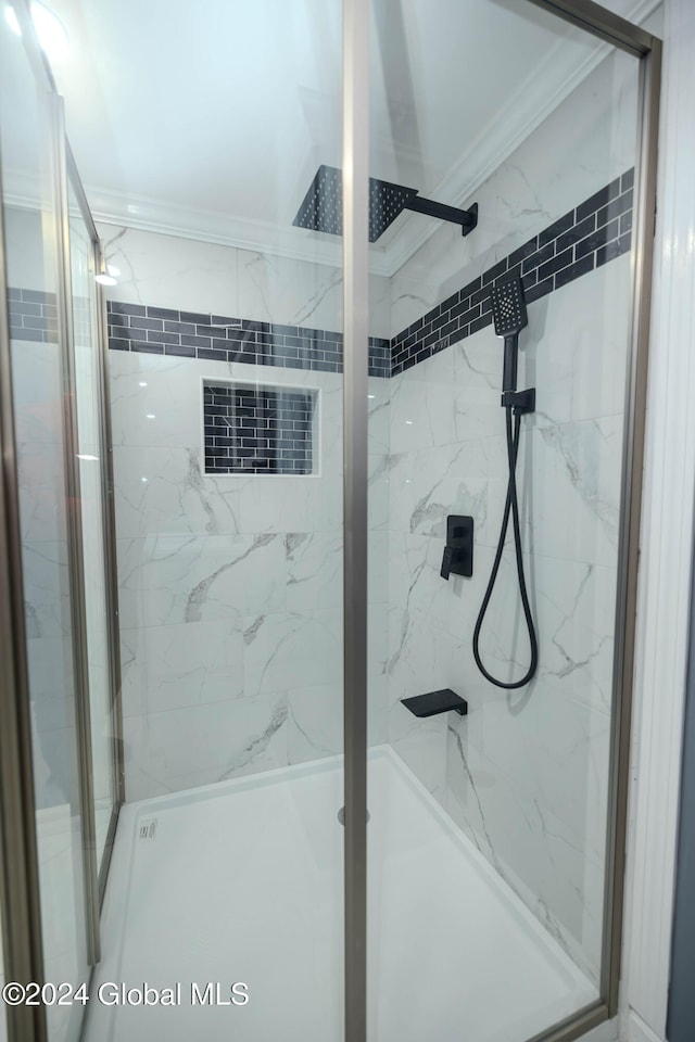 bathroom with an enclosed shower and crown molding