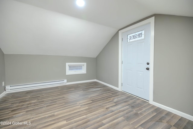 bonus room with lofted ceiling, baseboard heating, and dark wood-type flooring