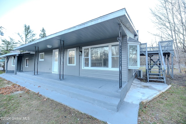 view of property exterior featuring cooling unit and covered porch