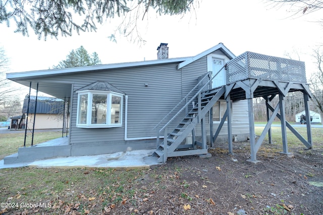 back of property featuring a wooden deck