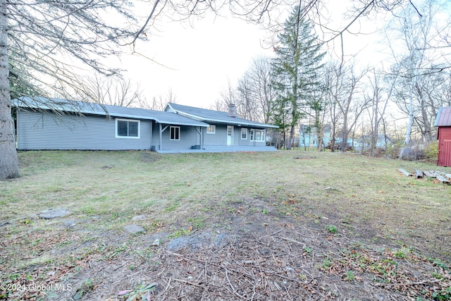 rear view of house featuring a lawn