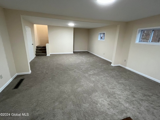 empty room featuring dark carpet