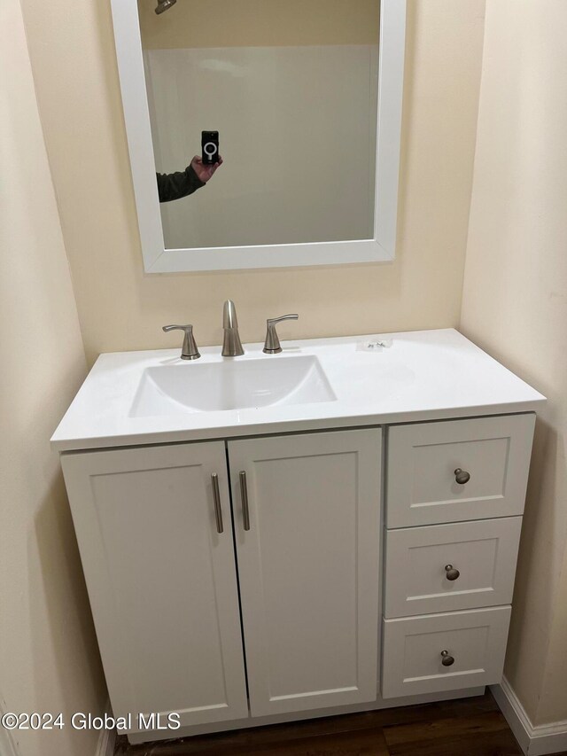 bathroom featuring hardwood / wood-style flooring and vanity