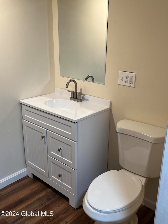 bathroom featuring hardwood / wood-style floors, vanity, and toilet