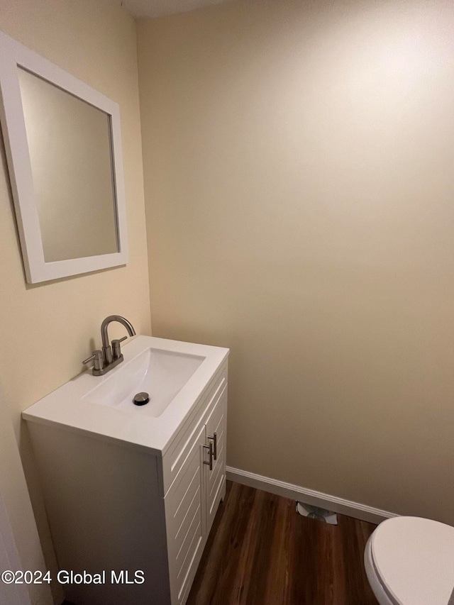 bathroom featuring vanity, toilet, and wood-type flooring