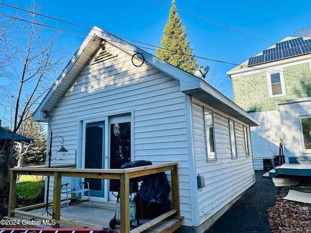 back of house featuring a wooden deck