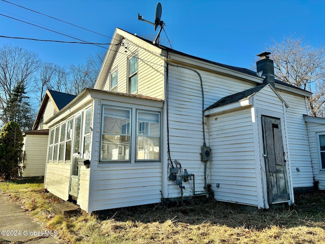 back of house with a sunroom