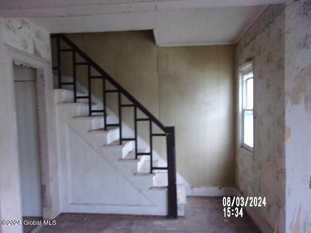 stairs with concrete flooring