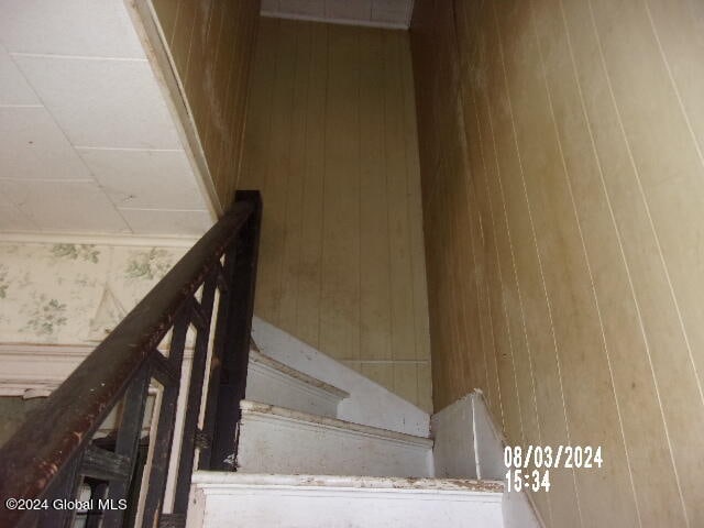 stairs featuring hardwood / wood-style floors