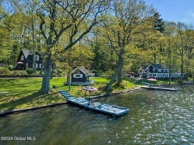 view of dock featuring a yard and a water view