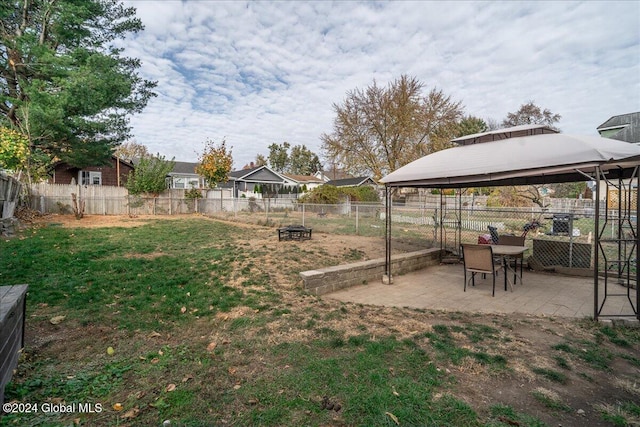 view of yard featuring a gazebo, an outdoor fire pit, and a patio