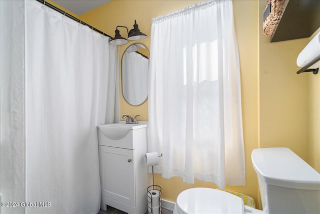 bathroom featuring vanity and toilet