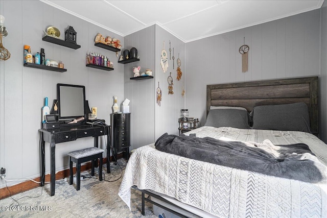 bedroom featuring light hardwood / wood-style floors, ornamental molding, and wooden walls