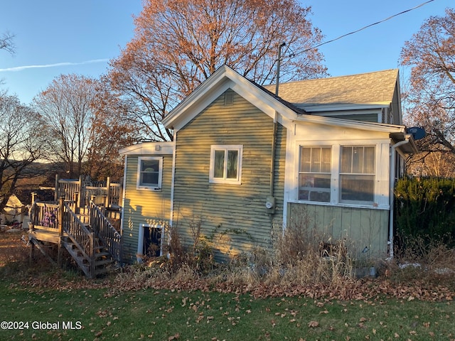 view of home's exterior featuring a yard and a deck