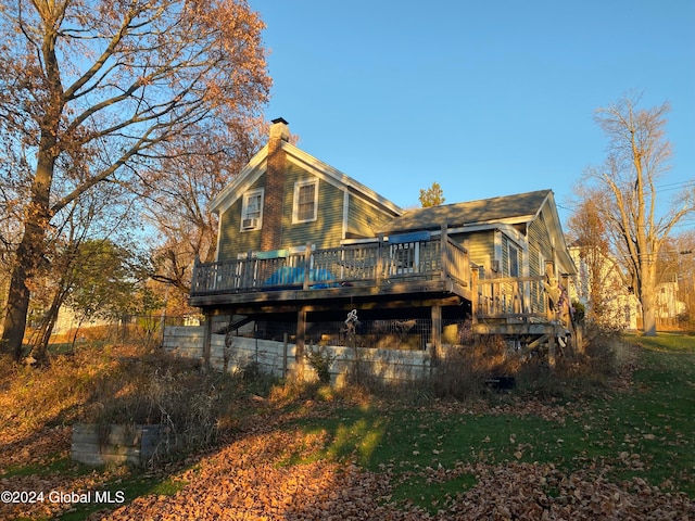 rear view of property featuring a wooden deck