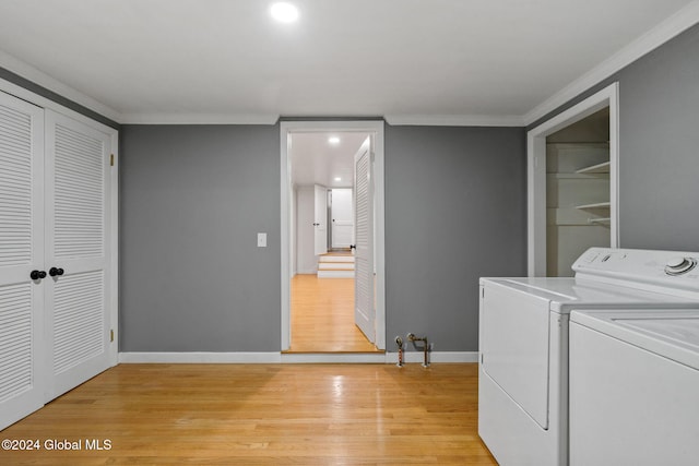 washroom with crown molding, light hardwood / wood-style floors, and independent washer and dryer