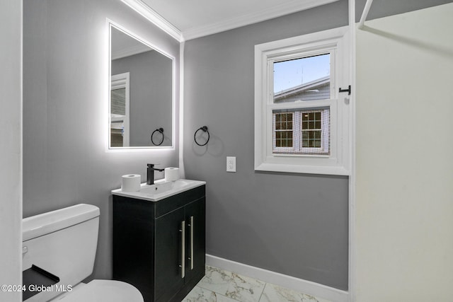 bathroom with crown molding, vanity, and toilet