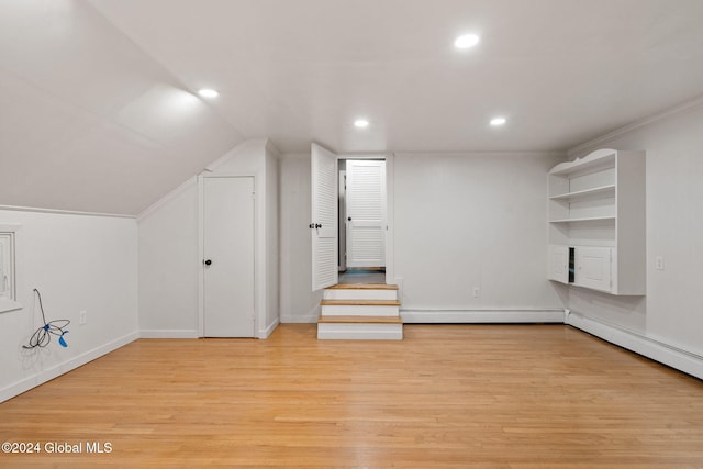 bonus room featuring vaulted ceiling, a baseboard heating unit, and light hardwood / wood-style flooring