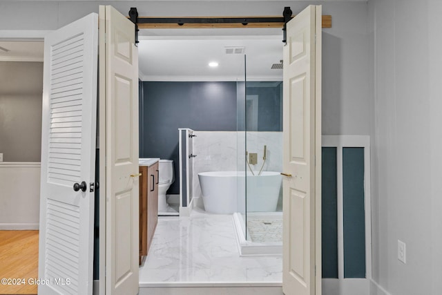 bathroom with a tub, hardwood / wood-style floors, and ornamental molding