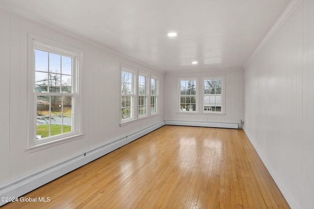 unfurnished sunroom featuring a baseboard heating unit