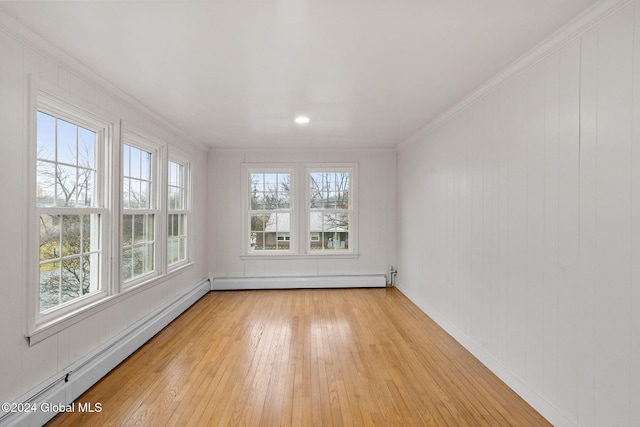 unfurnished sunroom featuring plenty of natural light and a baseboard heating unit