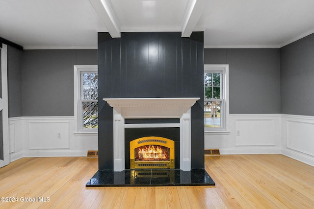 interior space with beamed ceiling, light hardwood / wood-style floors, and crown molding