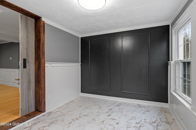 entrance foyer with light wood-type flooring and crown molding