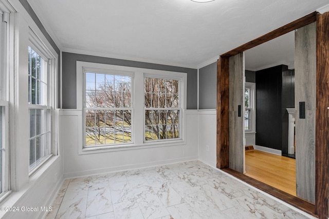 unfurnished room featuring light hardwood / wood-style floors and ornamental molding