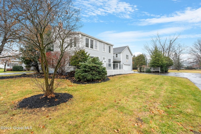 view of property exterior featuring a yard and a garage