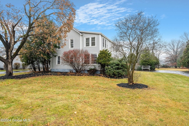 view of property exterior with a yard