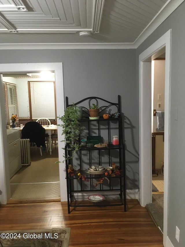 corridor with crown molding and hardwood / wood-style flooring