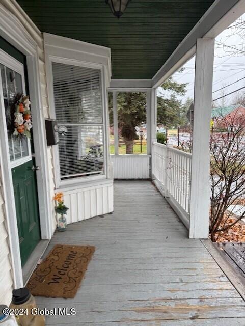 wooden terrace featuring covered porch