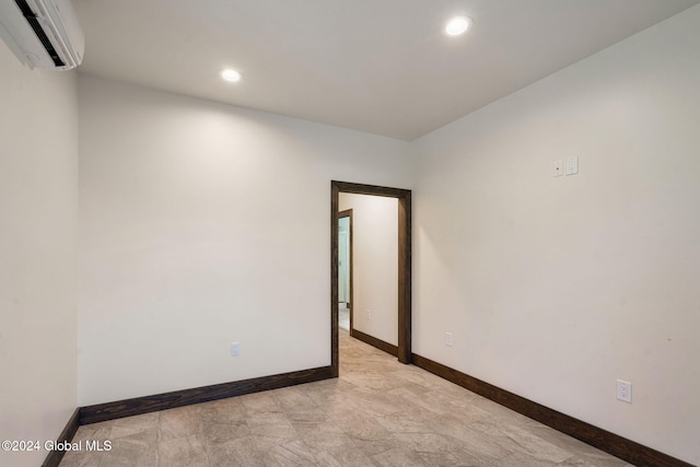 spare room featuring an AC wall unit