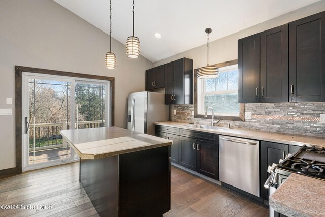 kitchen featuring plenty of natural light, lofted ceiling, sink, and stainless steel appliances