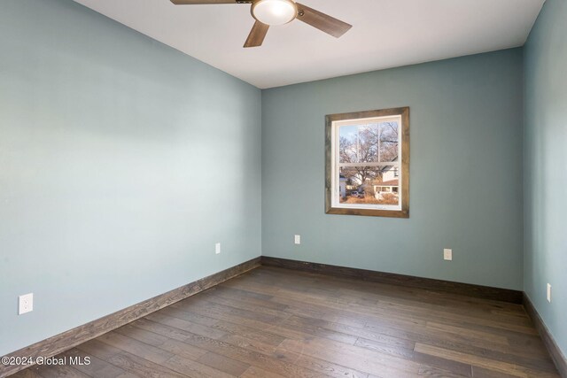 unfurnished room with ceiling fan and dark wood-type flooring